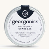 A tin of the Georganics charcoal toothsoap on a cream background