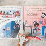 Pages of the No Home for a Ghost kids story book open on a white fluffy blanket