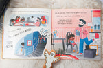 Pages of the No Home for a Ghost kids story book open on a white fluffy blanket