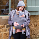 Front of mother carrying a baby in Close Caboo cotton blend soft structure Baby Carrier in olive