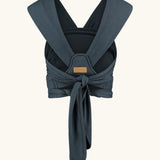 Close Caboo Organic Baby Carrier in blueberry back view, showing wide shoulder straps and tie waist adjustment strap