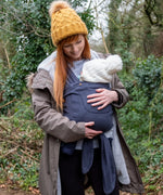 Front of Mother carrier a baby in a Close Caboo Organic Baby soft structure cotton Carrier in blueberry