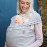 Front of mother carrier a baby in a Close Caboo Organic Baby soft structure cotton Carrier in porpoise showing wide shoulder straps 