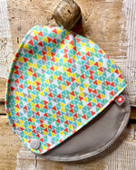 Close up of the Close breastfeeding pad pouch hanging on a wooden hook