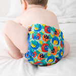 A baby wearing the Close Pop-In x Babipur exclusive reusable nappy wrap, in a Babipur Cwtch print
