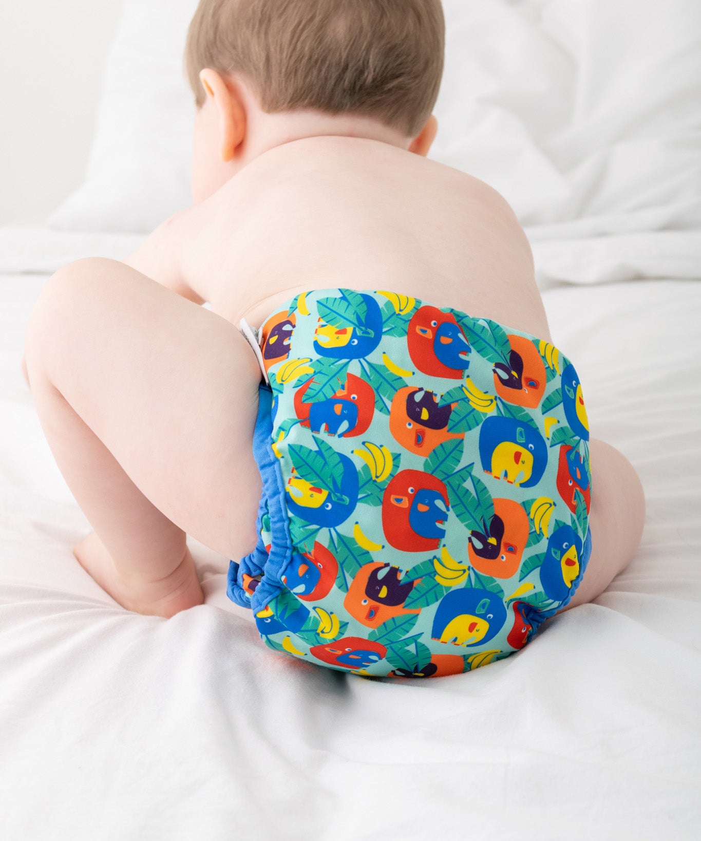 A baby wearing the Close Pop-In x Babipur exclusive reusable nappy wrap, in a Babipur Cwtch print