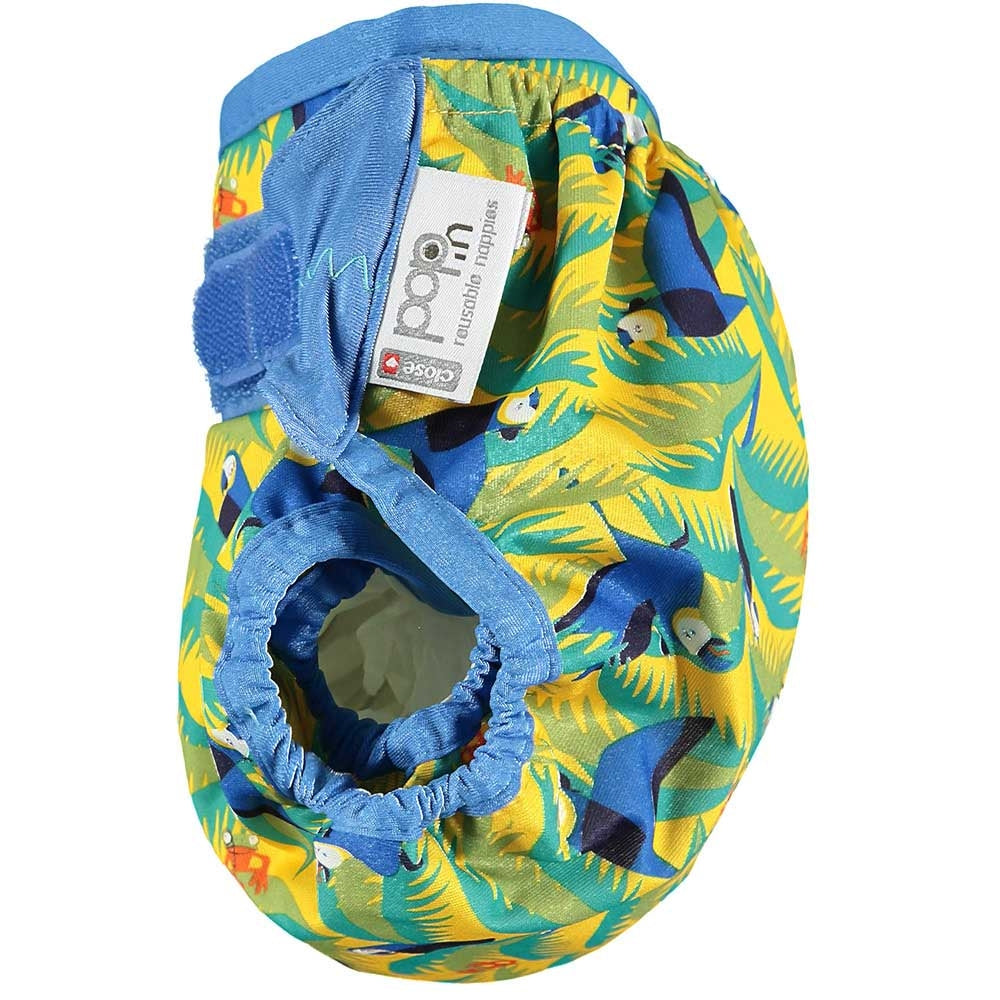 A side view of The Close Parent Pop-in reusable nappy wrap cover with velcro closures, in a parrot print
