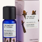 Organic Clove Bud pure essential oil in a blue glass bottle in front of a decorative pink cardboard box.