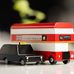 Close up of the Candylab wooden London Bus and London Taxi toys on a white background