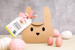 Cocoa Loco fairtrade white chocolate and raspberry mini easter eggs on a cream worktop next to some pink and white chocolate eggs