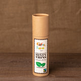 Tube of Cocoa Loco organic Fairtrade dark chocolate and mint thins on a wooden background