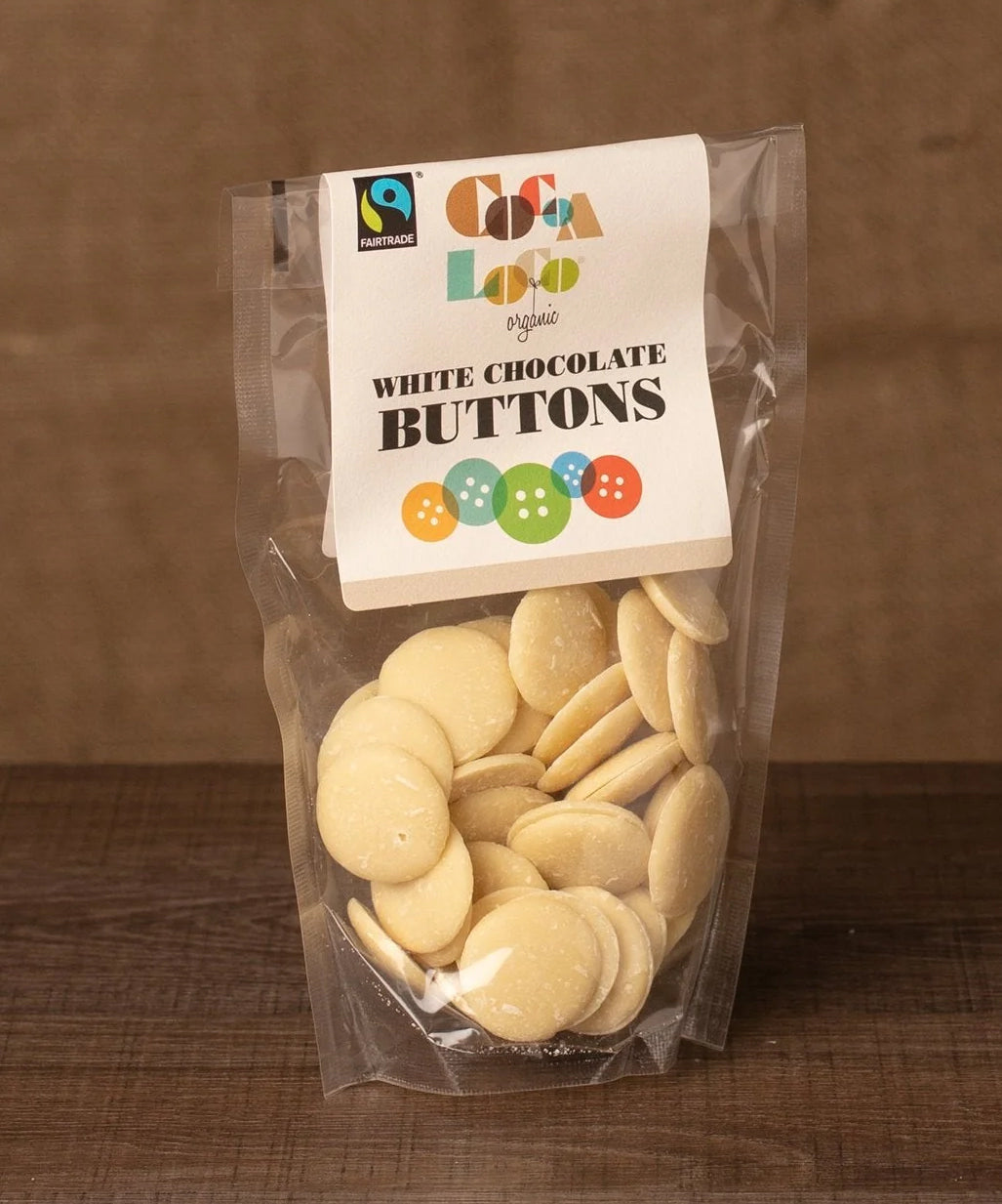 Cocoa Loco White Chocolate Buttons in a 100g pack. These white chocolate buttons are organic, Fairtrade and free from UPF.