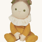 Olli Ella Cora Corn in a velvet yellow outfit, plush peach collar, white skin, green eyes, light hair tied up with little green leaf hair accessory, on a cream background
