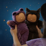 A child holding up the two Olli Ella Cozy bat dinkum dolls. Ozzy a umber brown coloured bat and Pip a purple bat. These soft toys are part of Olli Ella's Halloween collection available here at Babipur.