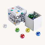 Cuboro 15 coloured glass marbles in their cardboard box on a cream background