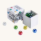 Cuboro 15 coloured glass marbles in their cardboard box on a cream background