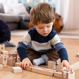 Child playing with the Cuboro junior marble set, set up on the floor.