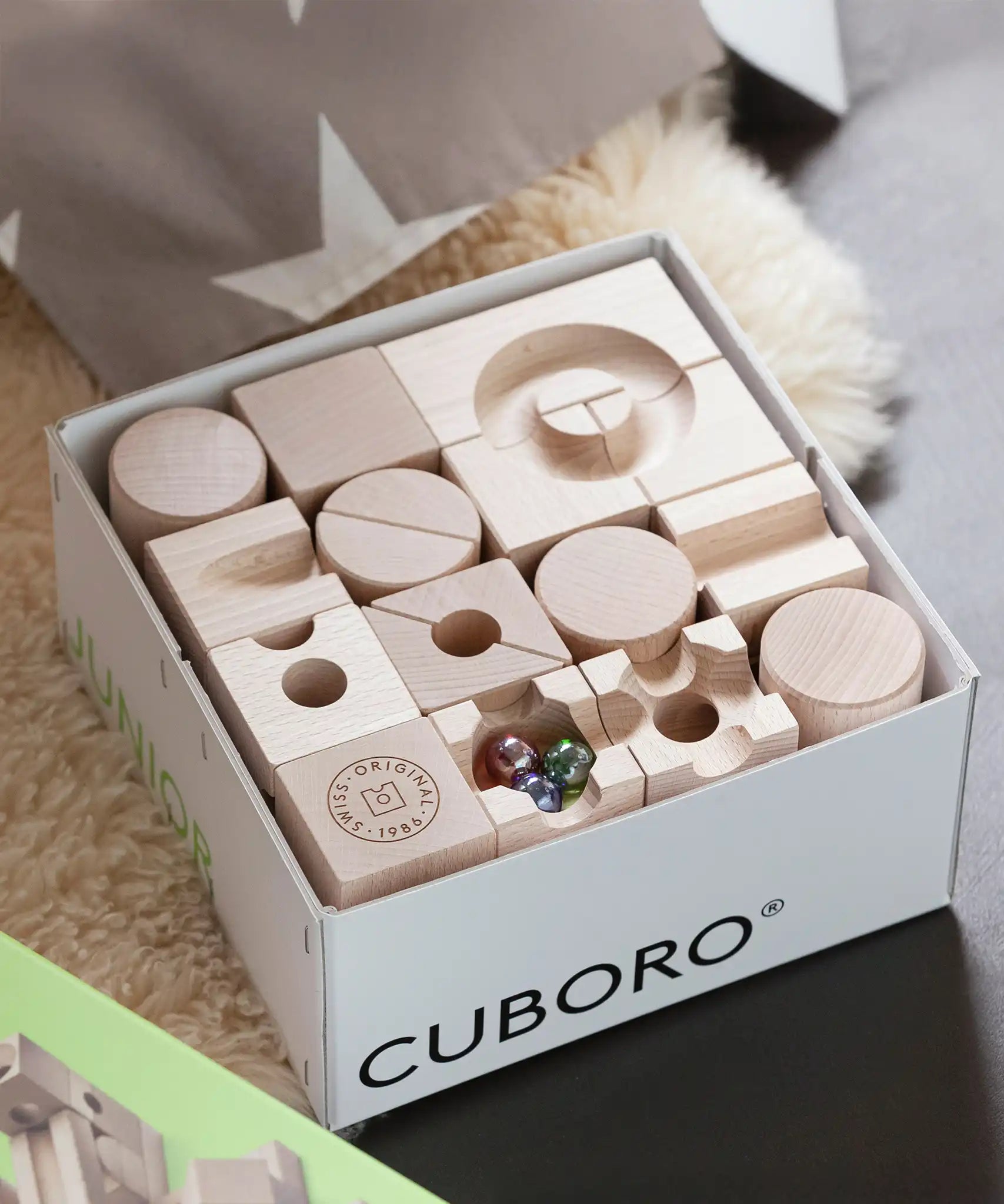 Close up of the contents of the Cuboro junior marble set in it's box.