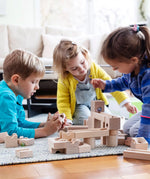 Children playing with the Cuboro junior marble set, set up on the floor.