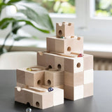 Cuboro standard 50 piece wooden marble run set up on a table with marbles placed in the track.