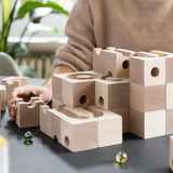 Cuboro standard 50 piece wooden marble run being set up on a table.