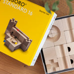Close up of the Cuboro 16 block marble run set in its box on a wooden floor