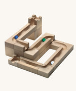 The Cuboro WAVE wooden marble run extender set - set up on its own with three marbles running down the track