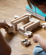 Children building the Cuboro WAVE wooden marble run extender set