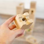 A close up of a wooden block from the Cuboro sub set.