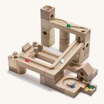 Cuboro wooden marble run junior set built into a geometric marble run on a cream background