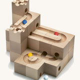 Cuboro Standard 32-piece wooden marble run building blocks stacked on a cream background