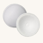 Two white breast pads which are included in the Lola & Lykke Breastfeeding Starter Kit