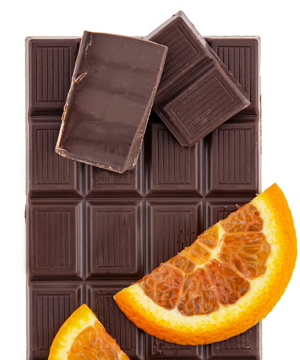 dark chocolate with broken off pieces and slices of orange