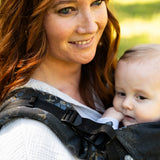 Mother wearing a Didymos didyfix baby carrier in blue blossom showing close up of padded adjustable shoulder strap 