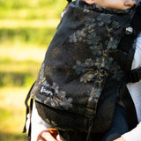 Didymos didyfix carrier in blue blossom with a baby sitting inside showing close up of the design on cotton fabric