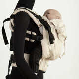 Side of Didymos didyfix carrier in linen cream shown on mannequin. A soft structured full buckle carrier made from cotton