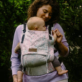 Mother carrying a baby in the frontal position in the Didymos didyfix soft structured full buckle carrier in summer mosaic