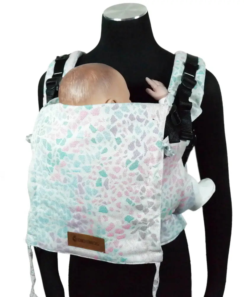 Front of Didymos didyfix carrier in summer mosaic shown on mannequin. A soft structured full buckle carrier made from cotton