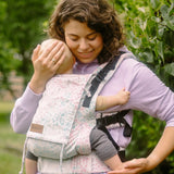 Mother carrying a baby in the Summer mosaic Didymos didyfix full buckle soft structured cotton carrier in the frontal position 