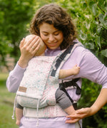 Mother carrying a baby in the Summer mosaic Didymos didyfix full buckle soft structured cotton carrier in the frontal position 