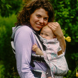 Side of mother carrying baby in the Summer mosaic Didymos didyfix soft structured cotton carrier in the frontal position 