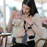 Mother carrying a baby in the Zephyr Didymos didyfix full buckle cotton carrier in the frontal position 