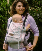 Mother with a baby sitting inside a Summer mosaic Didymos didyfix soft structured cotton carrier 