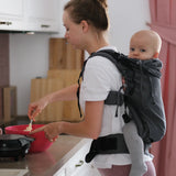 Side of woman carring a small child on the back with a Didymos didyfix double anthracite toddler carrier