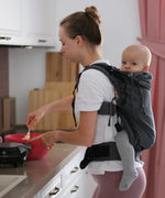 Side of woman carring a small child on the back with a Didymos didyfix double anthracite toddler carrier