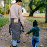 Mother and child walking in a park with a metro monochrom Didymos didyfix carrier loose and around the waist