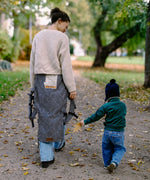 Mother and child walking in a park with a metro monochrom Didymos didyfix carrier loose and around the waist