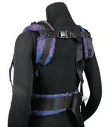 Back of a Didymos didyfix baby carrier in mosaic in the dark shown on mannequin. showing padded shoulder straps and buckle fasteners