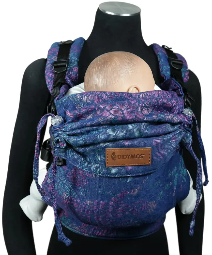 Front of Didymos didyfix carrier in mosaic in the dark design shown on a mannequin. A soft structured full buckle carrier made from cotton