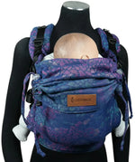 Front of Didymos didyfix carrier in mosaic in the dark design shown on a mannequin. A soft structured full buckle carrier made from cotton